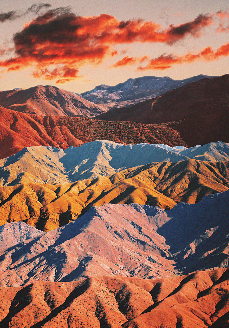 Mountain ranges in different colors creating natural lines in a barren landscape.
