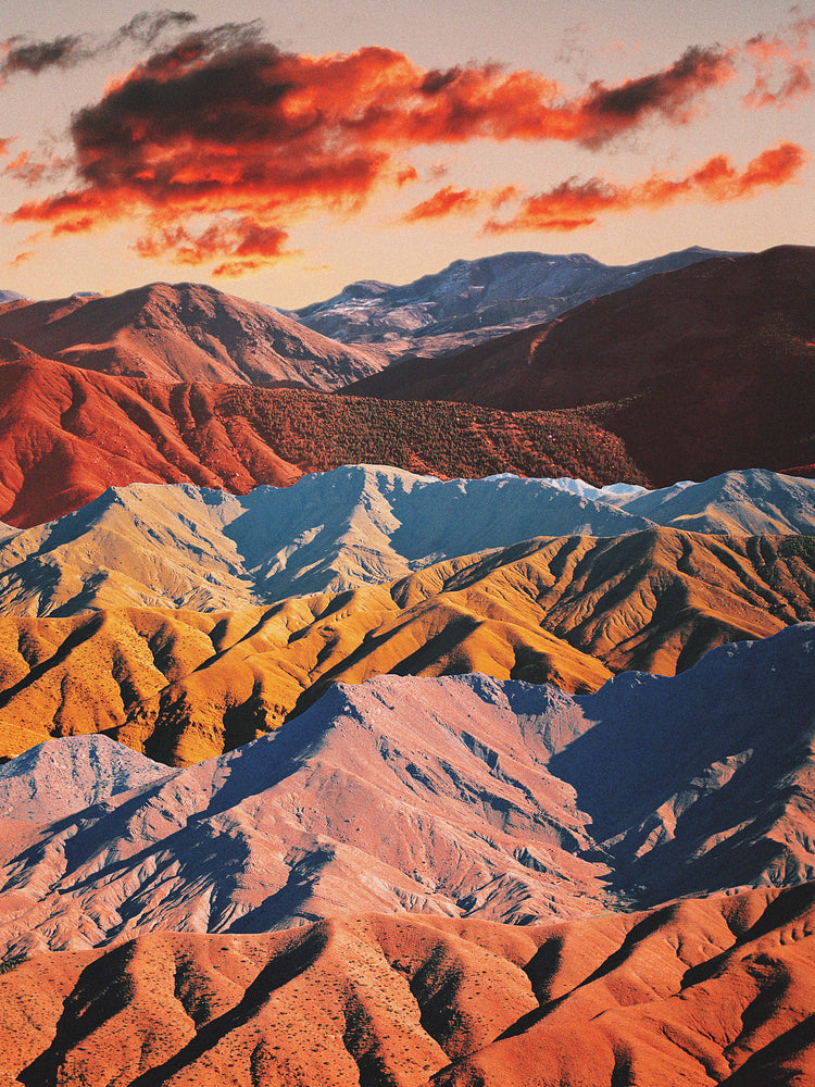 Mountain ranges in different colors creating natural lines in a barren landscape.