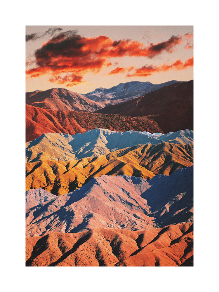 Mountain ranges in different colors creating natural lines in a barren landscape.