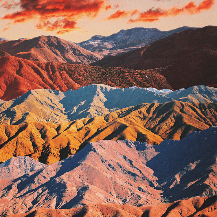 Mountain ranges in different colors creating natural lines in a barren landscape.