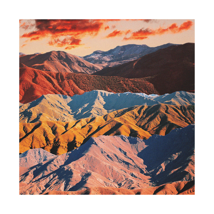 Mountain ranges in different colors creating natural lines in a barren landscape.