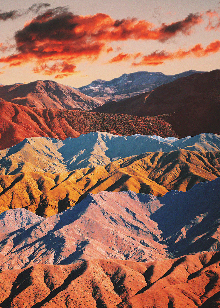 Mountain ranges in different colors creating natural lines in a barren landscape.
