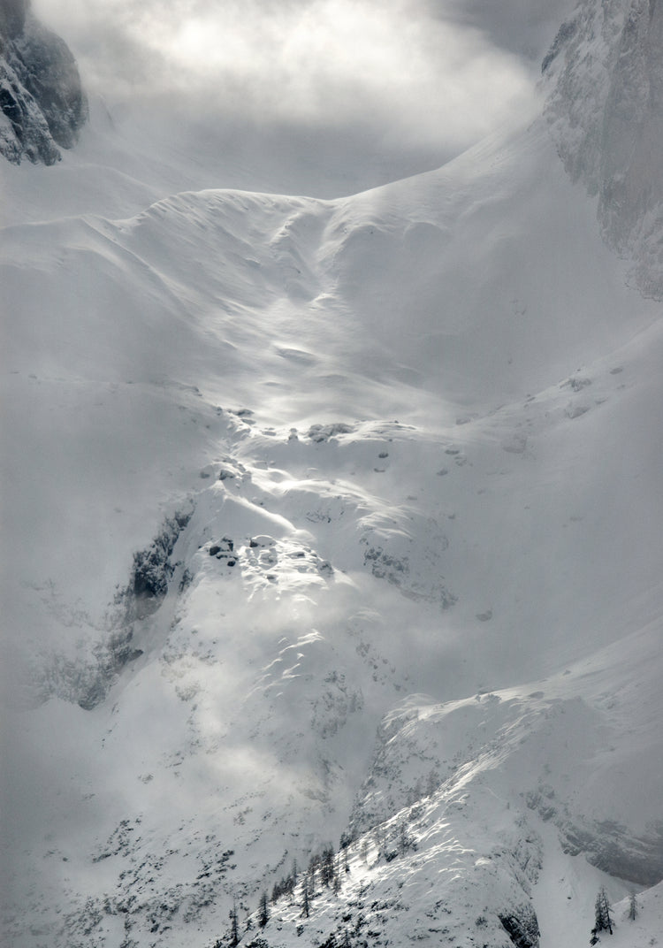A barren mountain side covered in snow and ice.
