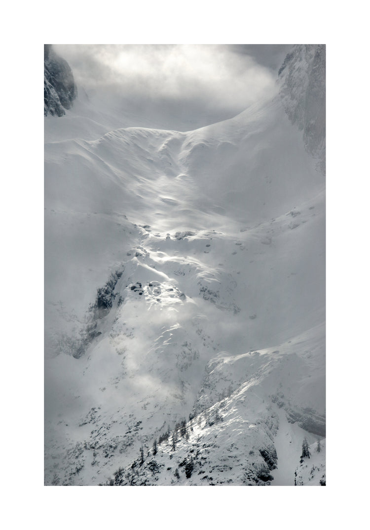 A barren mountain side covered in snow and ice.