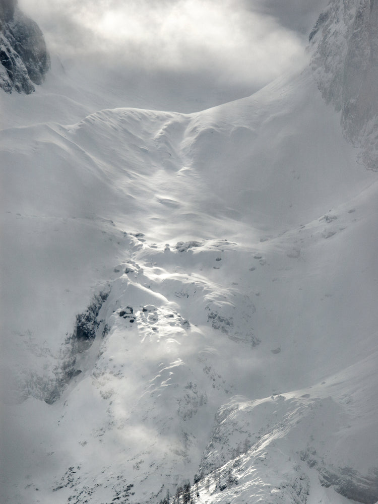 A barren mountain side covered in snow and ice.