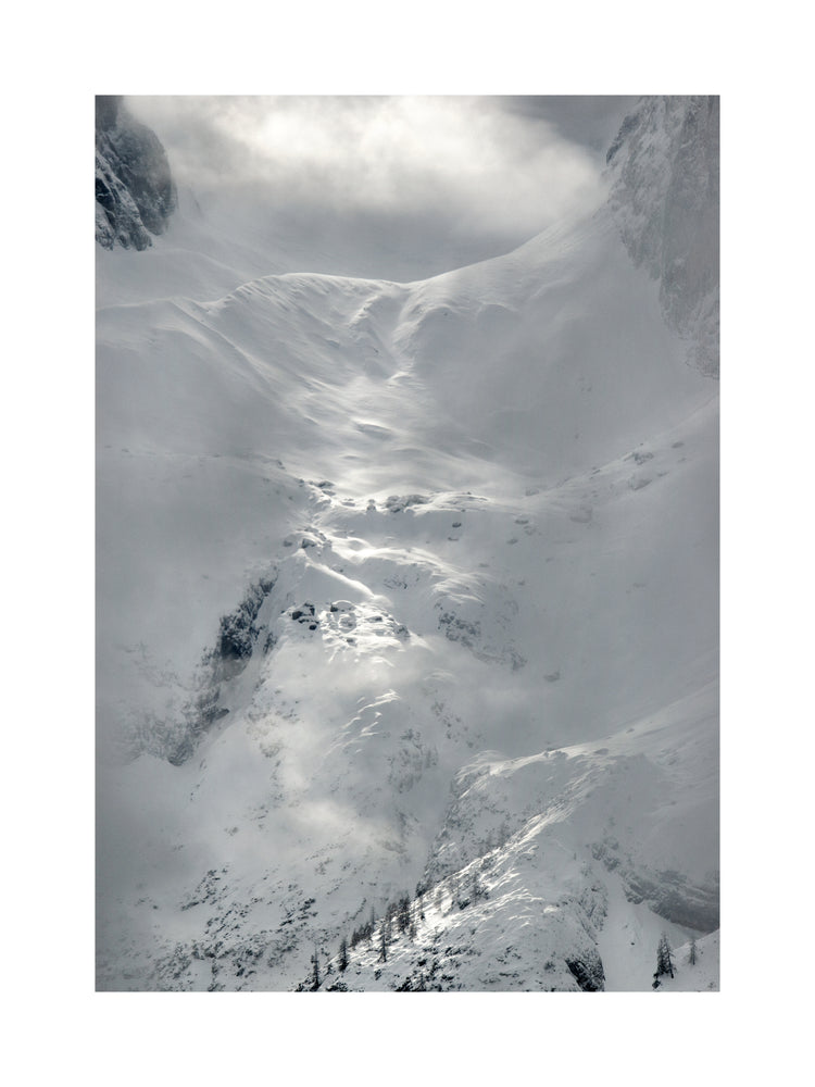 A barren mountain side covered in snow and ice.