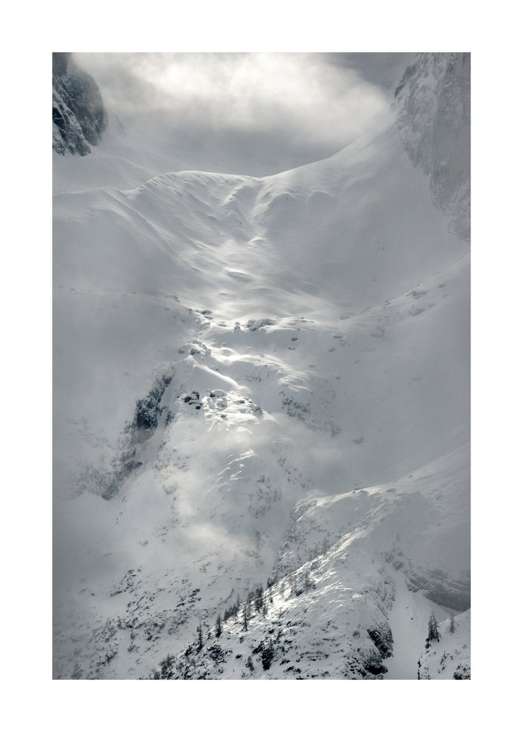 A barren mountain side covered in snow and ice.