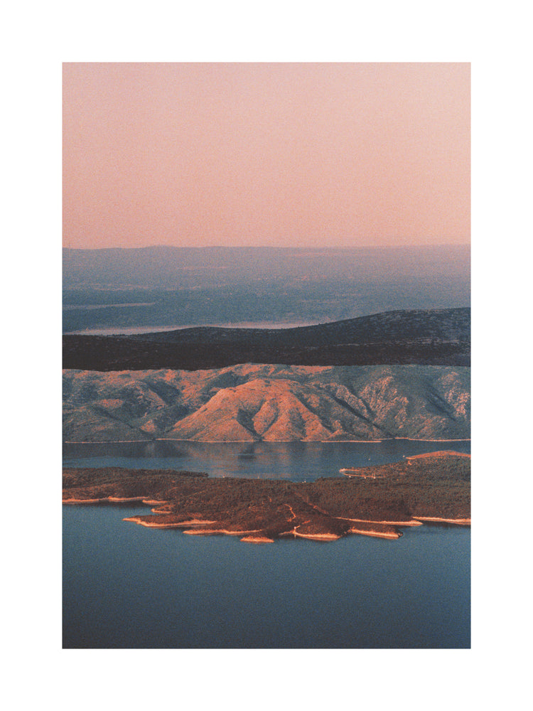 Landscape scenery with mountains and forests and lakes under crimson sky.
