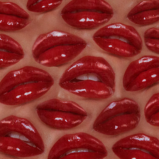 A pattern made from a bunch of shiny red lips.