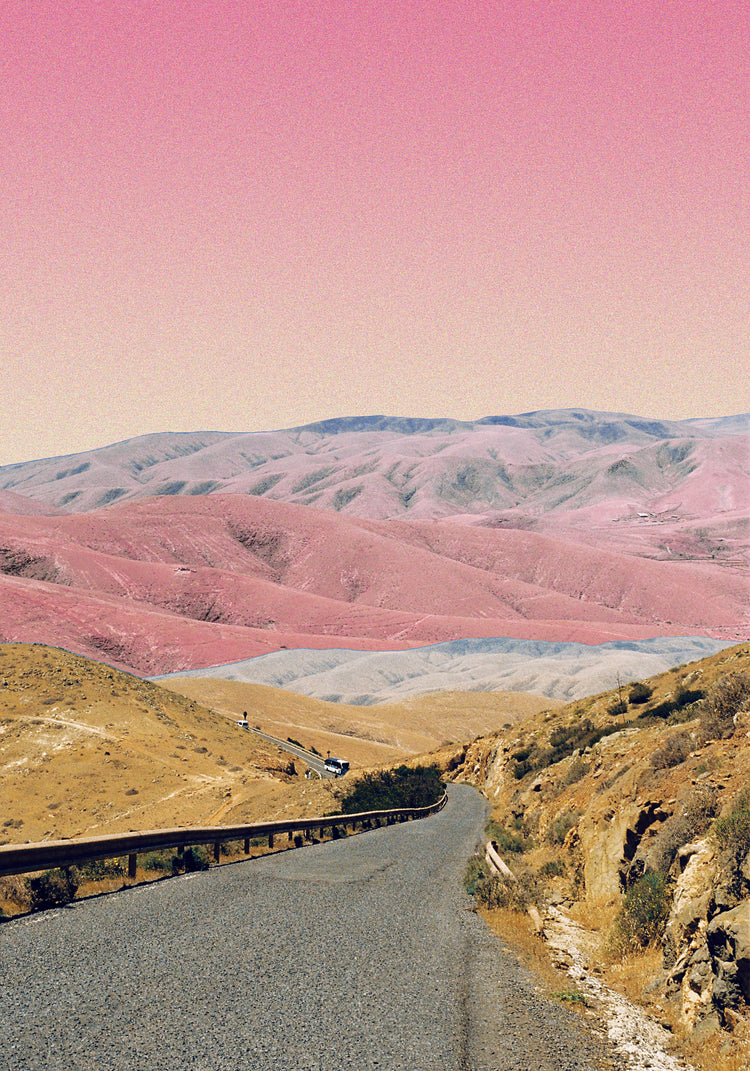 Technicolor scenic landscape with pink and purple mountains under a pink sky.
