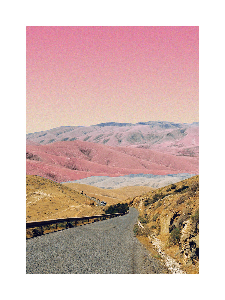 Technicolor scenic landscape with pink and purple mountains under a pink sky.