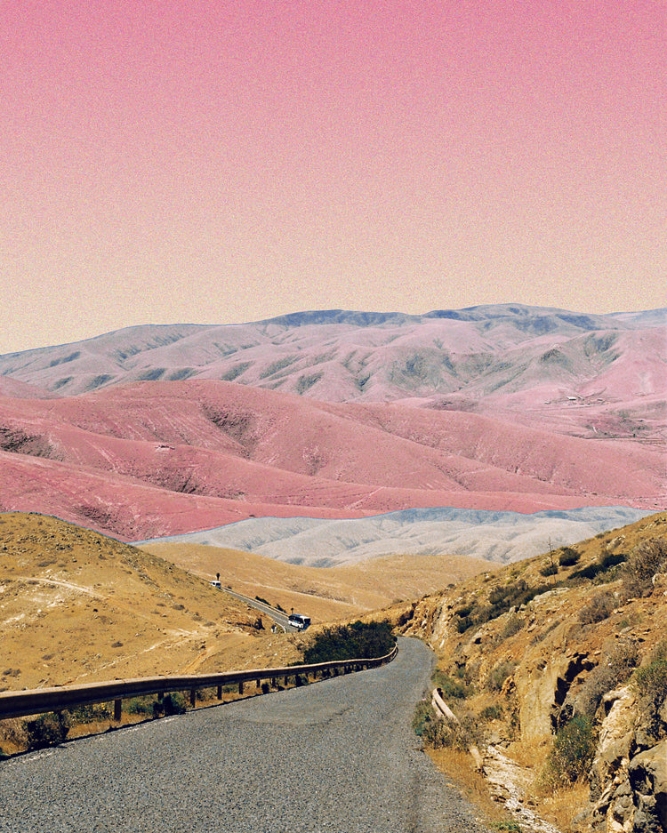 Technicolor scenic landscape with pink and purple mountains under a pink sky.