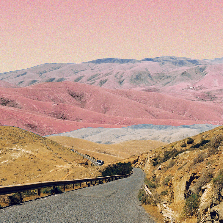Technicolor scenic landscape with pink and purple mountains under a pink sky.