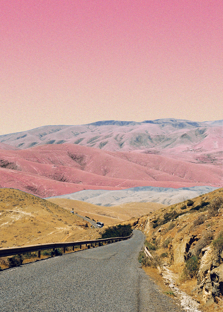 Technicolor scenic landscape with pink and purple mountains under a pink sky.