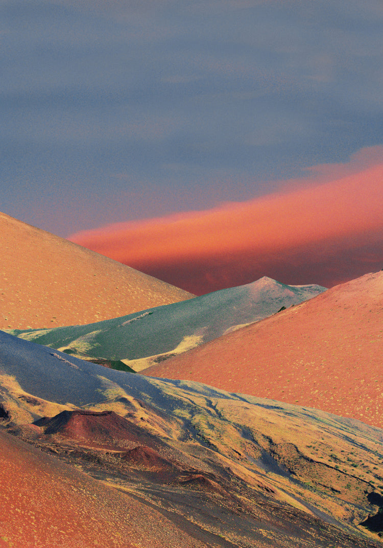 Colorful mountain scenery sparkling under a blue sky with crimson clouds.