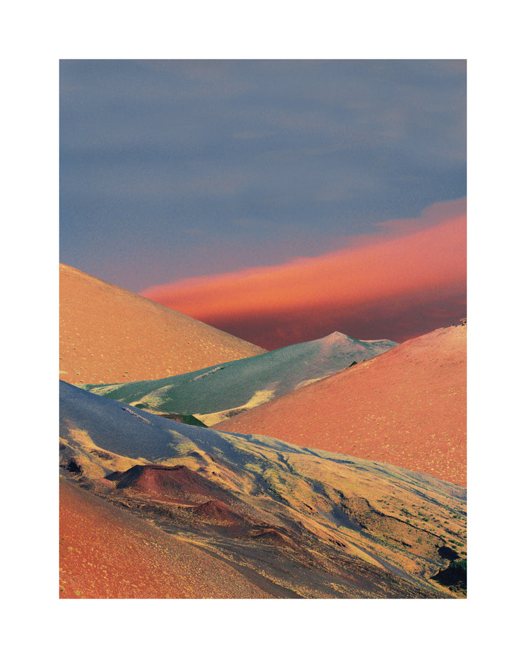 Colorful mountain scenery sparkling under a blue sky with crimson clouds.