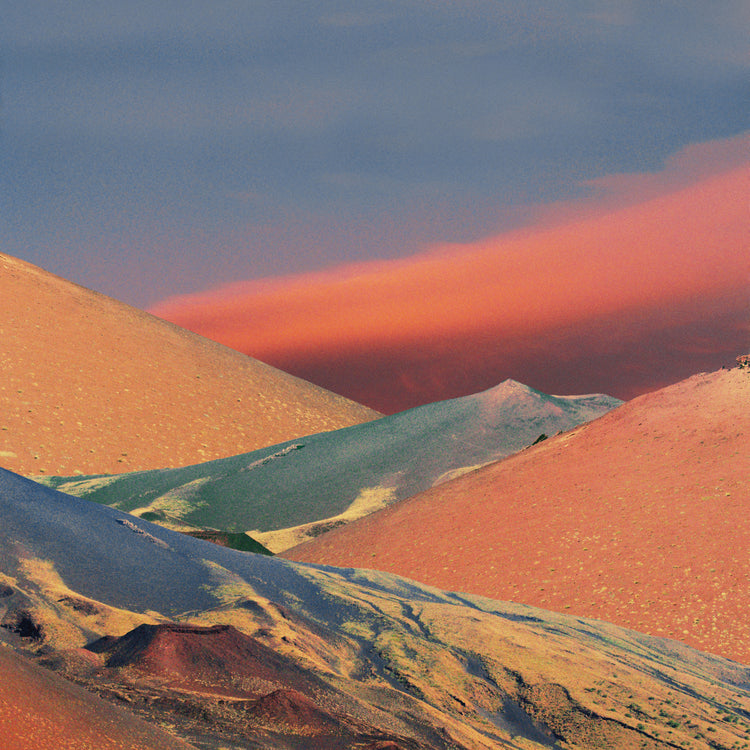 Colorful mountain scenery sparkling under a blue sky with crimson clouds.