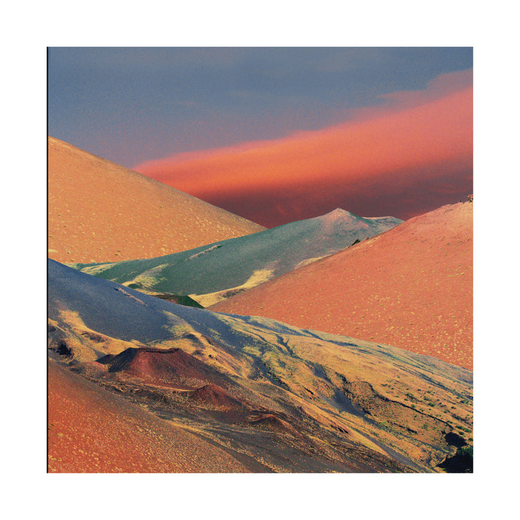 Colorful mountain scenery sparkling under a blue sky with crimson clouds.