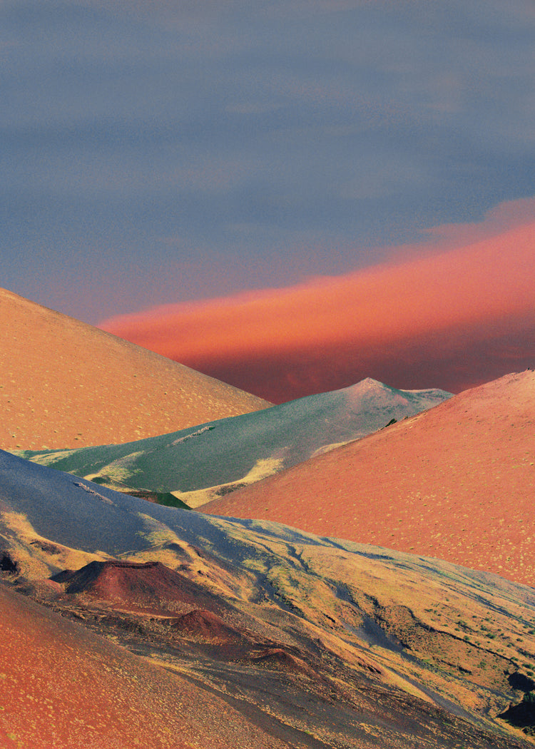 Colorful mountain scenery sparkling under a blue sky with crimson clouds.