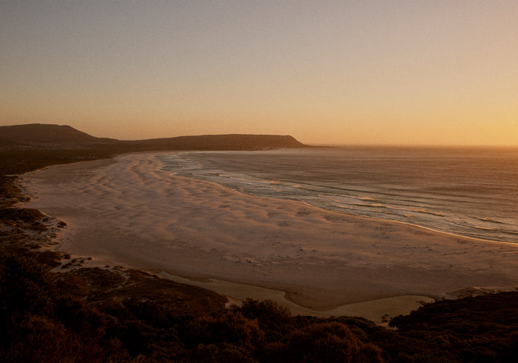 Shoreline during low tide captured at sunset.