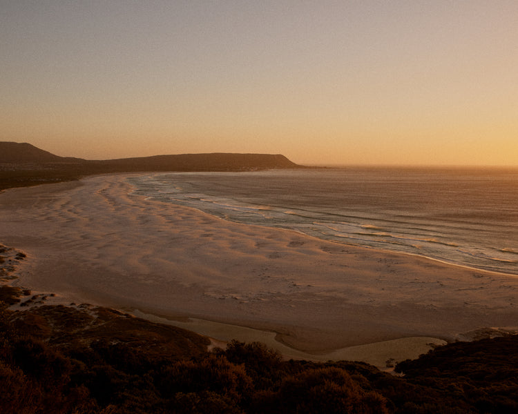 Shoreline during low tide captured at sunset.