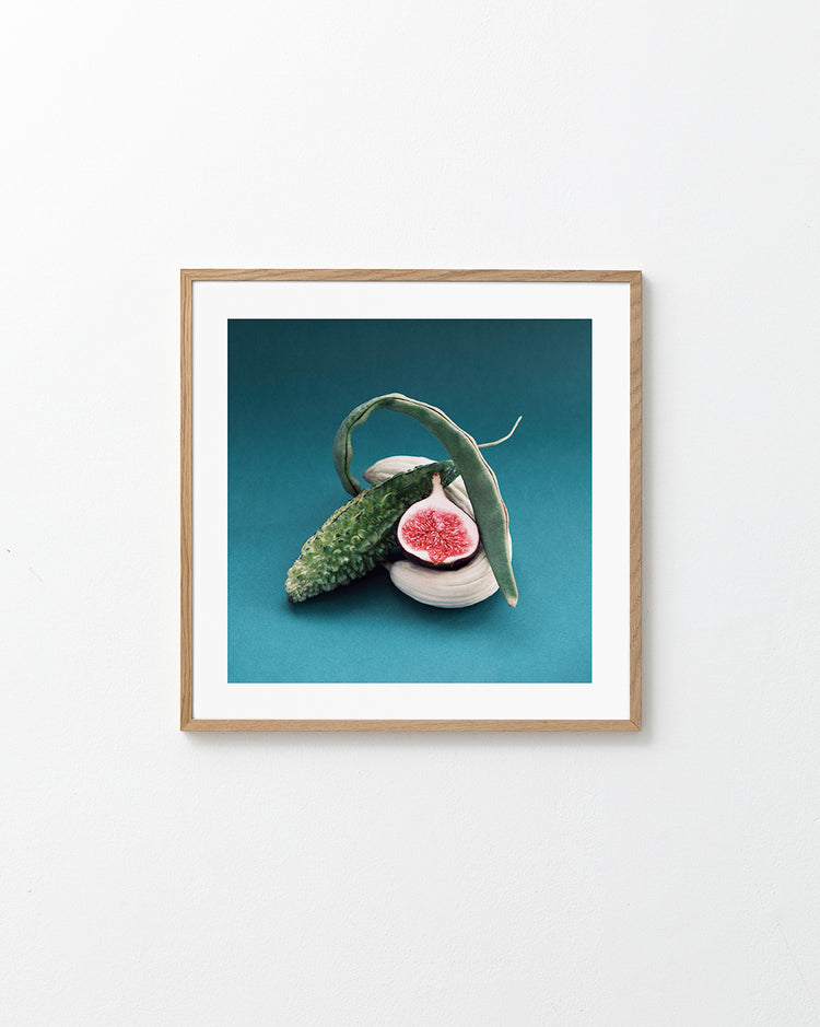 Different fruits and vegetables stacked together on a turquoise canvas.