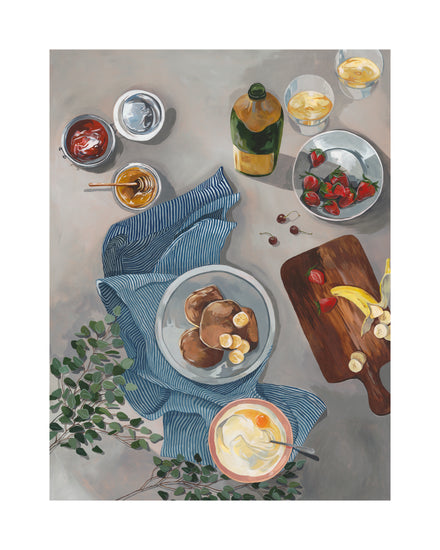 The Breakfast of Champions Poster depicts a delightful scene with fluffy pancakes, bananas on a striped cloth, a wooden board filled with more bananas and strawberries, along with yogurt, marmalade, honey, olive oil, and greenery for a fresh touch.