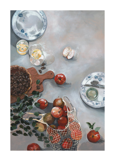 The How Do You Like These Apples Poster showcases a cozy kitchen table scene with red apples in a net bag, nuts on a wooden board, two blue-patterned china plates, and lemon-slice drinks. A partially peeled apple and a green leafy branch add to the warm decor set against a soft gray background.