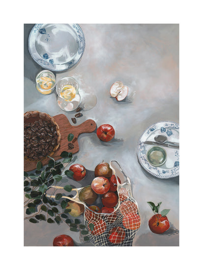 The How Do You Like These Apples Poster features a kitchen table still life with red apples spilling from a net bag, an empty blue and white plate, a wooden bowl of coffee beans, greenery sprigs, and two glasses of water with lemon slices, adding warmth to the decor.
