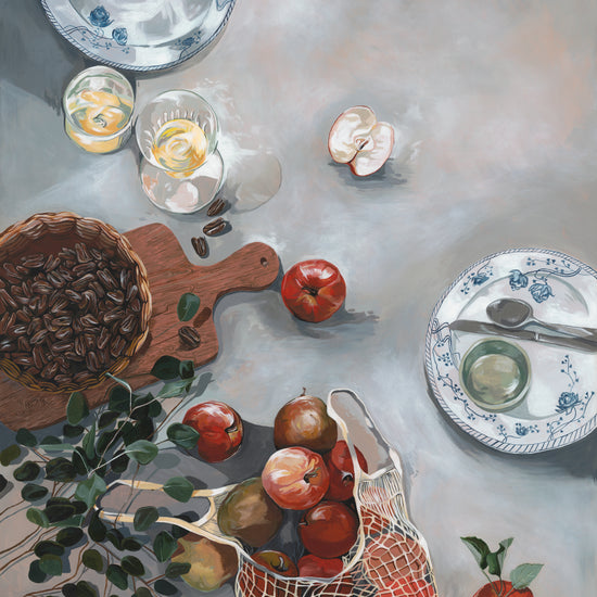 The How Do You Like These Apples Poster features a cozy kitchen scene: red apples, a basket of seeds, two drinks, a net bag of apples, and plates on the table. A plant branch and mushroom add to the warm rustic vibe.