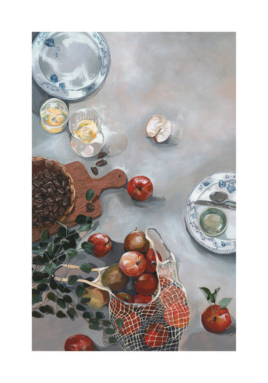 The How Do You Like These Apples Poster showcases a still life with red apples spilling from a net bag onto a cozy kitchen table, accompanied by a wooden board with seeds, two glasses of beverages, blue-and-white plates, cutlery, and an elegant plant vine draping over the scene.