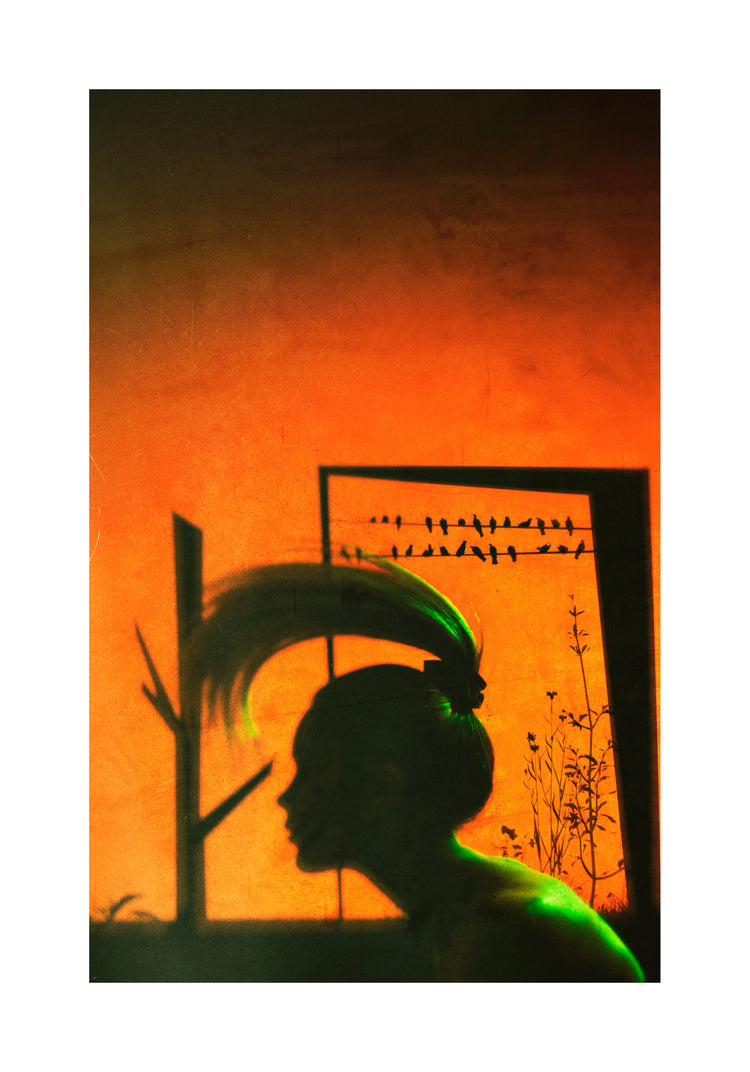 A woman with a ponytail doing a hair flip in an orange room.