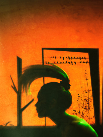 A woman with a ponytail doing a hair flip in an orange room.