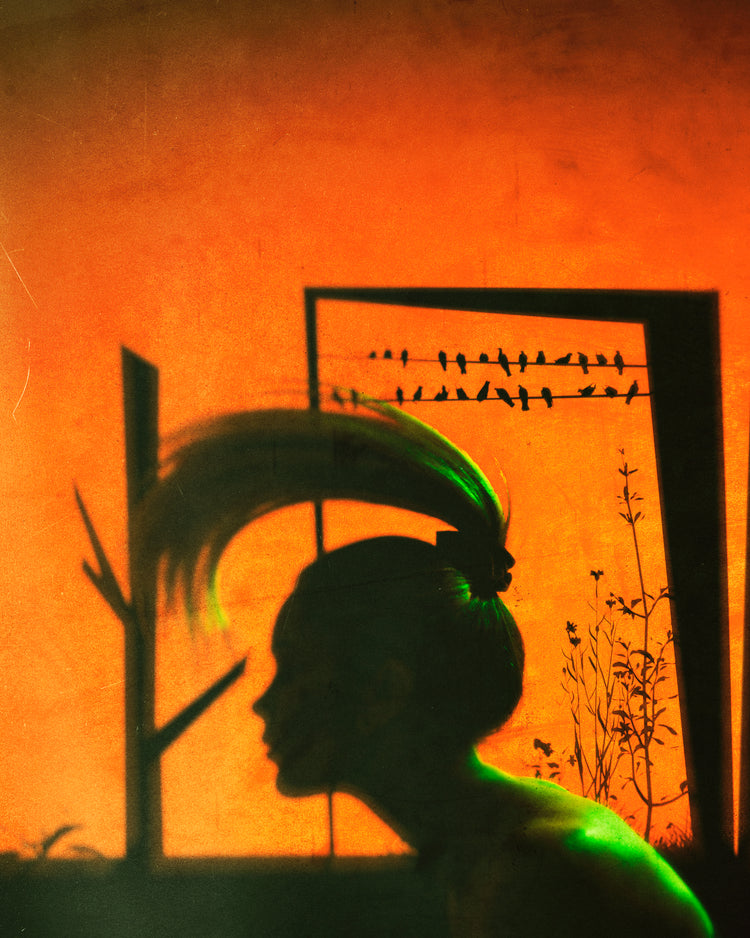 A woman with a ponytail doing a hair flip in an orange room.
