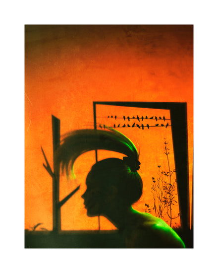 A woman with a ponytail doing a hair flip in an orange room.