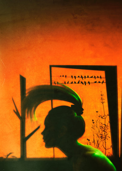 A woman with a ponytail doing a hair flip in an orange room.