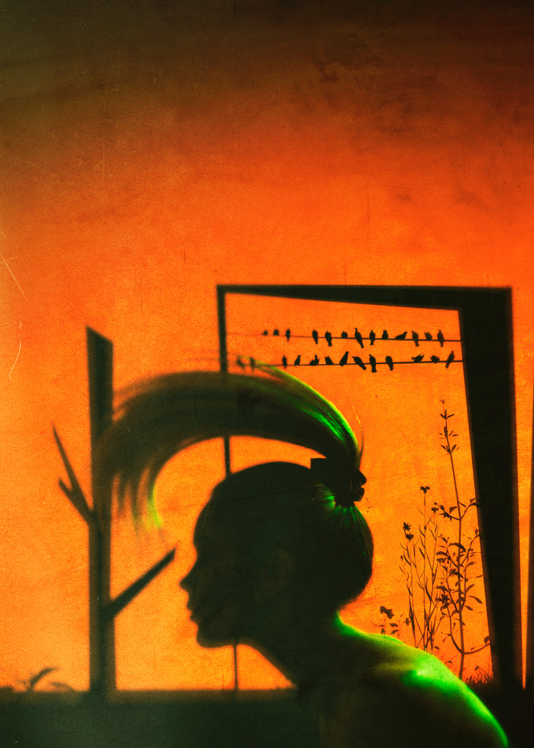 A woman with a ponytail doing a hair flip in an orange room.
