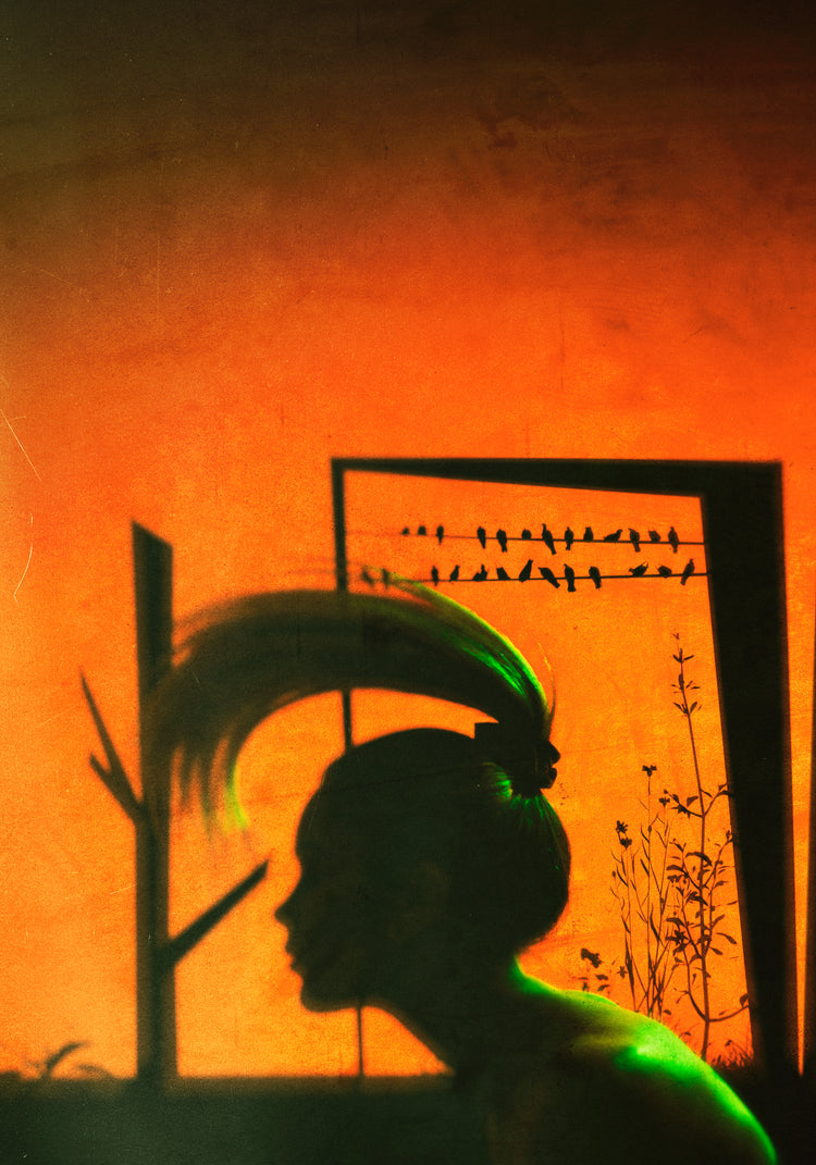 A woman with a ponytail doing a hair flip in an orange room.