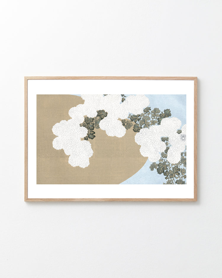 Framed artwork with white flowers on a beige and blue background