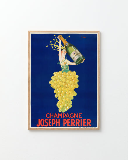 The Champagne Joseph Perrier Poster features a vintage Art Deco design with a woman in a grape-cluster dress holding a Champagne bottle against a deep blue background. Bold red letters at the bottom read Champagne Joseph Perrier, all set within an elegant light wood frame.