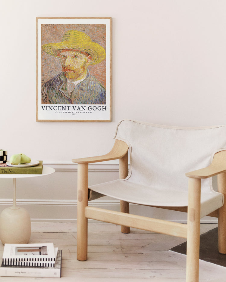 Framed Vincent Van Gogh artwork above a modern chair in a minimalistic room.