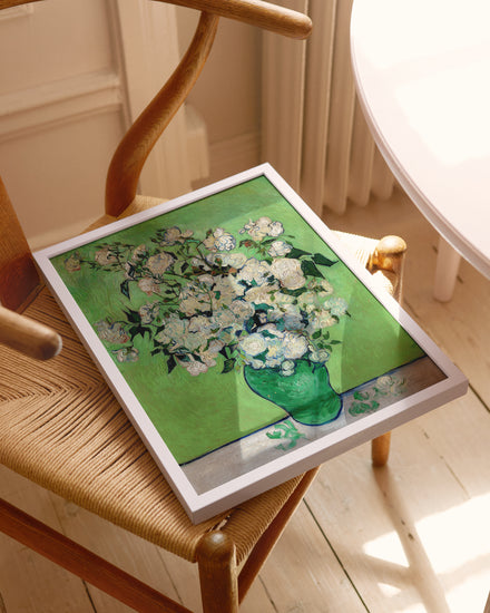 Framed artwork of a floral design on a wooden chair.