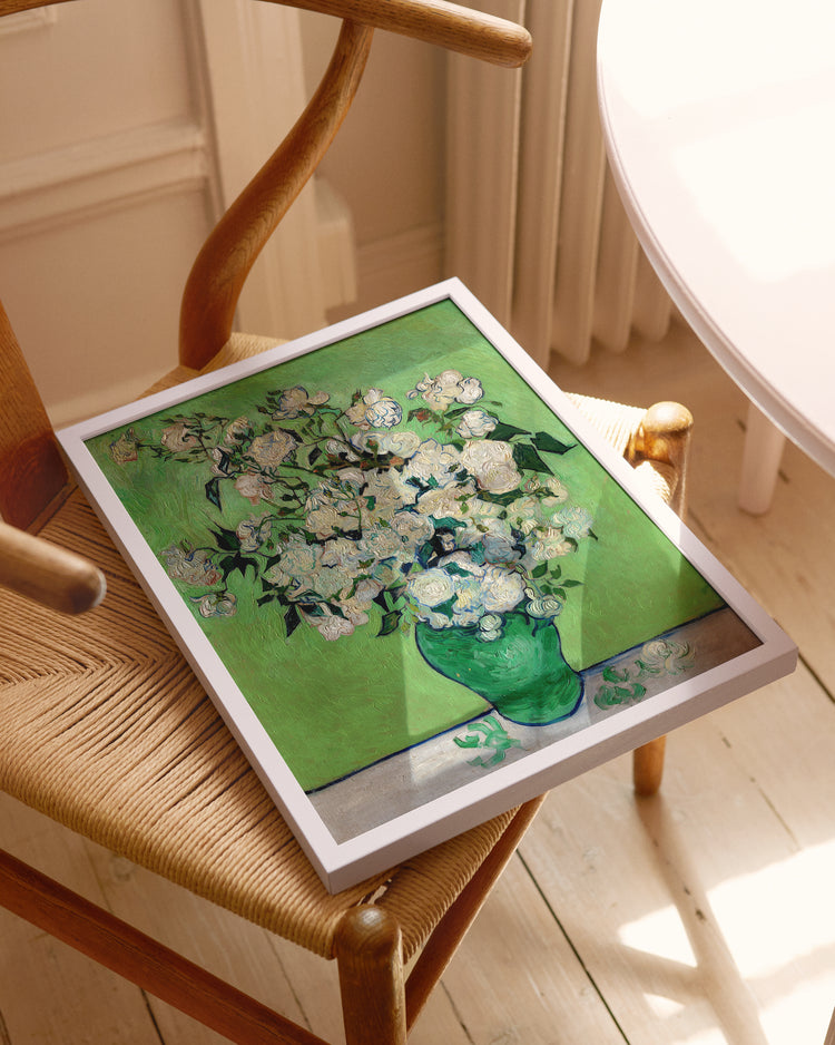 Framed artwork of a floral design on a wooden chair.