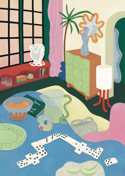 The room bursts with color and abstract flair, showcasing a cloth-wrapped table adorned with dominoes, a book, glasses, and fruit. A potted plant, patterned vase, and decor items enhance the exotic styling around the Living Room Domino Poster by Frauke Schyroki.