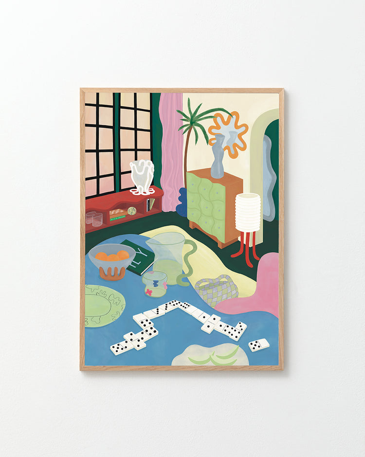 The Living Room Domino Poster showcases an abstract painting of a room with a large window, potted plant, decorative vase, and a domino set on the floor. The colorful artwork mixes geometric and organic shapes and is elegantly framed in wood on a white wall.