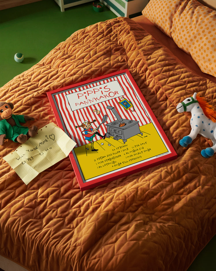 A Pippi Longstocking pancake poster placed on a neatly made bed in a children’s room.