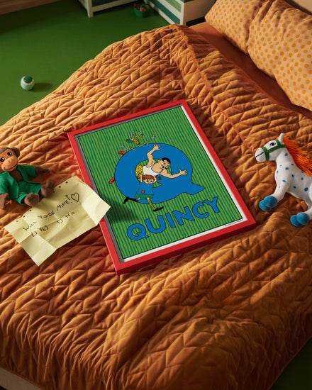 Pippi Longstocking name poster with the letter Q and the name Quincy, placed on a neatly made bed in a bright kids’ room.