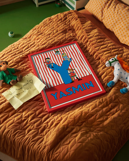Pippi Longstocking name poster with the letter Y and the name Yasmin, placed on a neatly made bed in a bright kids’ room.