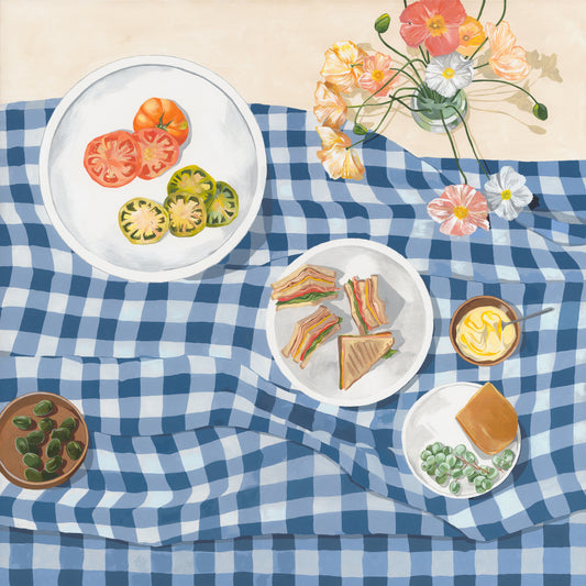The Poppies and Picnics Poster features a checkered blue tablecloth adorned with colorful sliced tomatoes, sandwiches, olives, and dips. A vase of pastel flowers adds to the charm, creating a bright and cheerful ambiance perfect for evoking a summertime romance picnic scene on your kitchen wall.