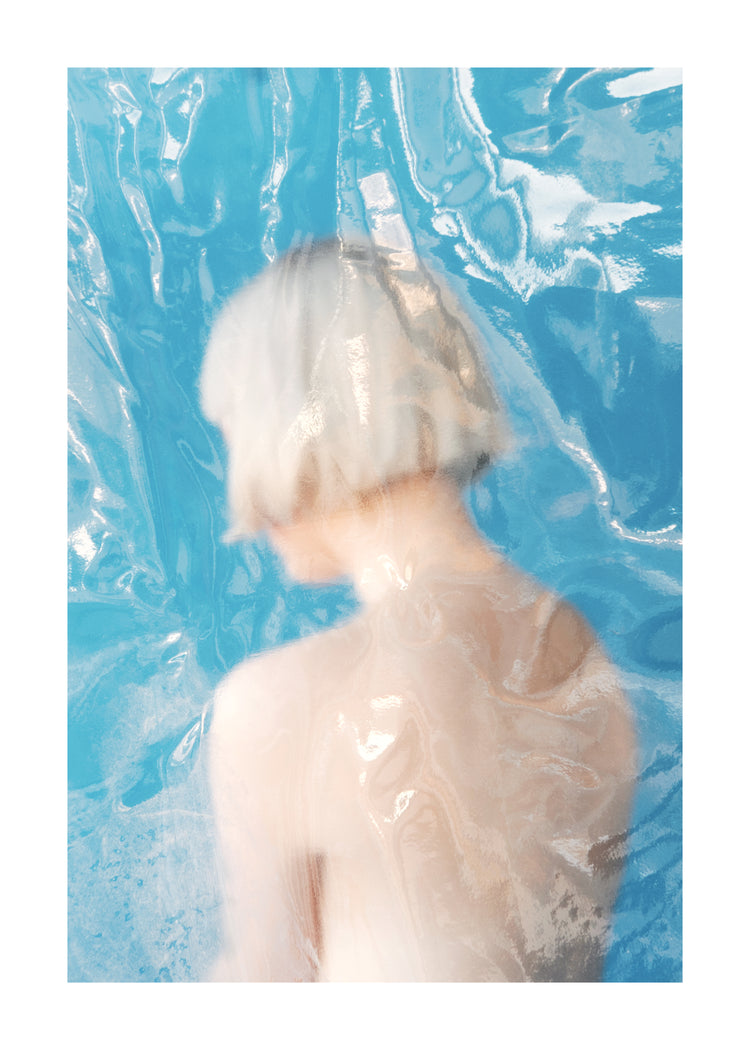 Short haired pale woman looking like a bust made from marble.